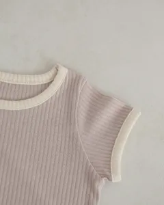 Ribbed baby t-shirt detail showing contrast color collar and short sleeves soft summer wear.