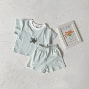 Detailed view of baby summer striped clothing set with cute turtle print, soft fabric.