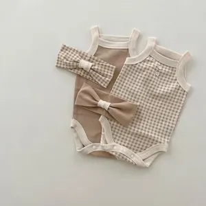 Detailed view of baby summer strap romper and matching headband set, cute design and soft fabric.