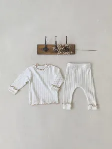 Detail view of baby girl ribbed long sleeve top and pants set with cute lettuce trim.