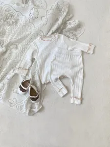 Infant baby girl lettuce edge long sleeve top and pants detail view, soft ribbed knit fabric.