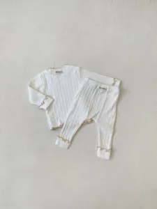 Infant ribbed long sleeve top and pants set with lettuce edge detail for baby girls.