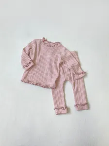 Cute baby girl pink ribbed long sleeve t-shirt and pants pajama set with lettuce edge.