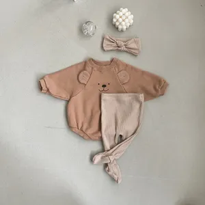 Details of the cute baby bear romper set with ribbed pants and matching headband in neutral tone.