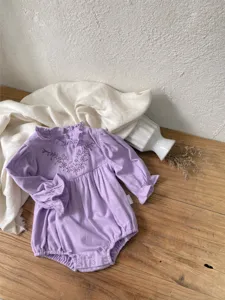 Cute infant baby girl floral embroidered ruffle collar long sleeve romper apparel detail view.