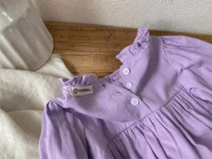 Infant baby girl light purple long sleeve romper detail view with bud collar and buttons