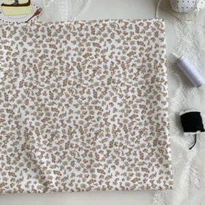 Brown floral cotton fabric detail shot, perfect for DIY handmade crafts and pastoral home decor.
