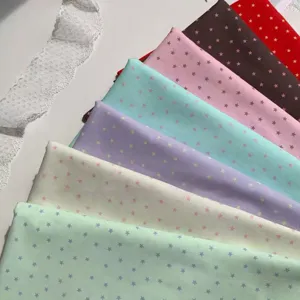 Close-up detail of colorful macaron star print DIY fabric, perfect for desktop photo backdrop.