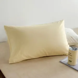 Close-up of soft minimalist Korean style yellow pillow bedroom decor detail view.