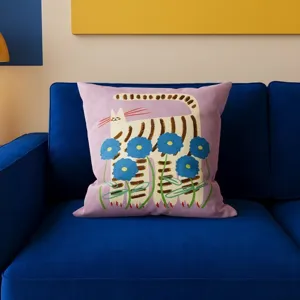 Close-up detail of the cute cat print cushion cover showing artistic floral pattern on blue sofa.