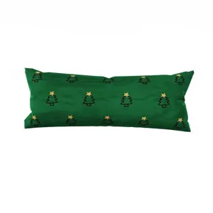 Primer plano detallado del cojín largo verde con estampado de pino navideño, suave decor