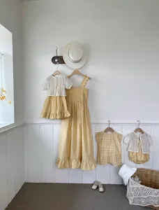 Cute baby summer cotton clothing set with yellow gingham dresses and delicate lace cardigans.