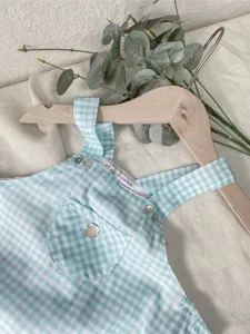 Baby girl blue gingham checkered gauze overalls, summer lightweight cute infant jumpsuit detail view.
