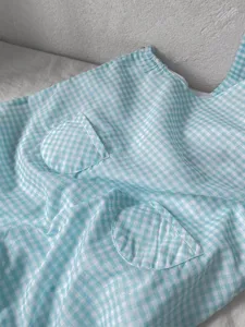 Blue white gingham baby overalls detail, lightweight cotton gauze fabric with cute round front pockets.