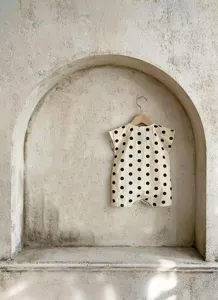 Infant sleeveless cotton baby romper with black polka dots, summer newborn bodysuit.