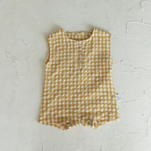 Detail shot of yellow white gingham baby sleeveless romper with buttons and snap crotch.