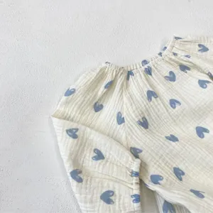 Infant baby girl cotton gauze romper with cute blue heart print, soft long sleeve design.