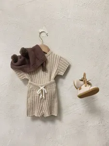 Detail ensemble tricot bebe printemps ete, pull doux manches courtes et short avec joli bonnet pompon.