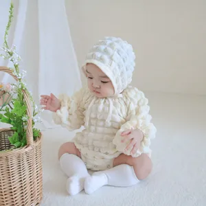 Infant waffle knit baby romper detail shot, soft newborn bodysuit with cute matching bonnet.