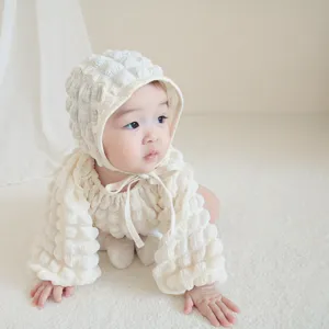 Infant baby bubble waffle long sleeve romper detail shot, soft cotton crawler outfit for newborn girls.