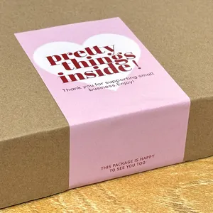 Pink rectangle belly band sticker detail, decorative sealing label for gift boxes and packaging.