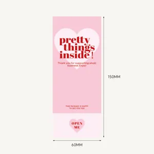 Pink rectangular gift box sealing sticker detail showing dimensions and lovely heart design.