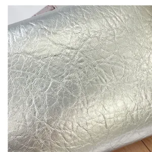 Detailed close-up view of the premium silver metallic crinkled leather shoulder bag texture.