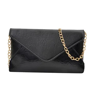 Fashionable black envelope shoulder bag with gold chain, trendy retro women crossbody bag.