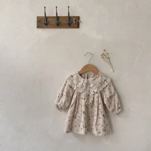Sweet floral baby girl dress detail, long sleeve lace collar toddler autumn clothing design.