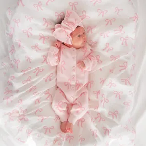 Infant baby girl pink knit romper with cute bow pattern and matching headband for autumn.