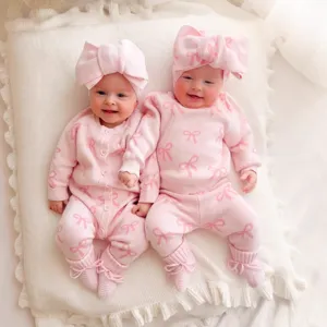 Cute baby girls pink knit sweater romper set with bow headband, cozy infant winter clothing.