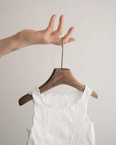 Close-up of girls solid color ruffled trim sleeveless crinkled cotton top detail view.