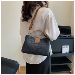 Black crocodile pattern shoulder bag with brown strap, stylish top handle handbag for women.