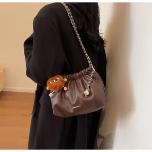 Stylish brown shoulder bag for women with chain strap, ruched design and cute furry charm.