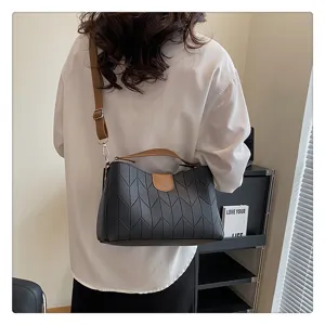 Detailed view of fashionable black and brown women's crossbody shoulder handbag tote.