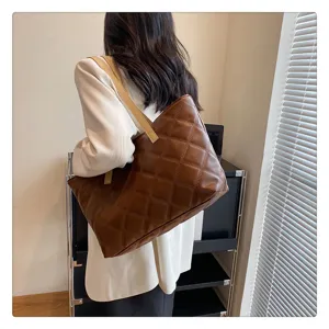 Quilted brown tote bag with shoulder straps, elegant casual daily commuter handbag style.