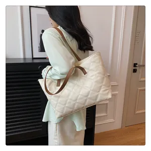 Detailed view of a chic quilted tote bag with brown straps, stylish and spacious for daily use.