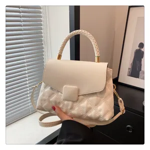 Stylish white quilted top handle bag with braided strap and flap closure for women casual chic.