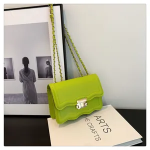 Trendy neon green wavy flap shoulder bag with metallic chain and secure lock for women.