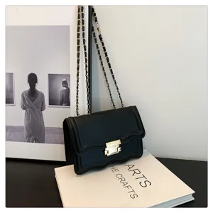 Black wavy chain crossbody bag for women, stylish minimalist shoulder bag with metal lock.