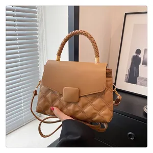 Chic brown flap shoulder bag with braided top handle and diamond quilted pattern for women.
