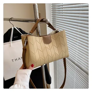 Stylish minimalist bamboo-textured women's tote bag detail, featuring brown handles and strap.