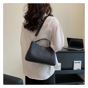 Women fashion black PU leather shoulder bag with geometric debossed pattern and stylish handle.