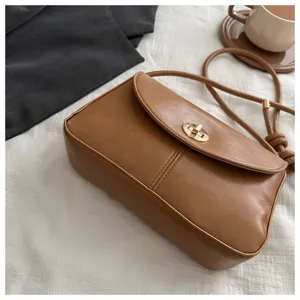 Vintage solid color small square shoulder bag with metal twist lock, stylish and chic.