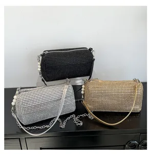 Detailed view of luxury rhinestone cylinder shoulder bags with pearl and chain straps.