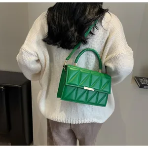 Stylish green quilted shoulder bag for women, elegant crossbody bag with metal lock design.