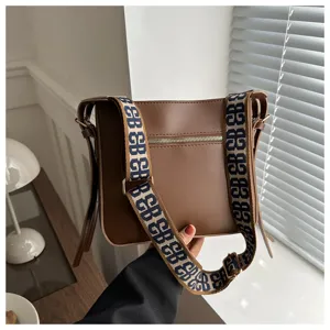 Chic brown women shoulder bag with wide pattern strap, large capacity daily commuting bag.