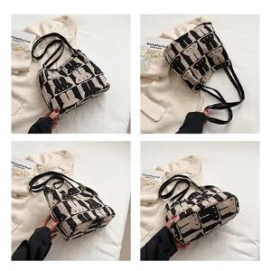 Fashionable black and white knitted tote bag for women, large capacity shoulder bag.