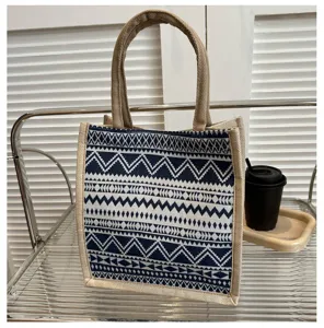 Ethnic style canvas tote bag detail view, blue and white geometric pattern, durable jute handle.