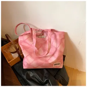 Pink quilted tote bag detail shot, showcasing soft fabric texture and magnetic closure.